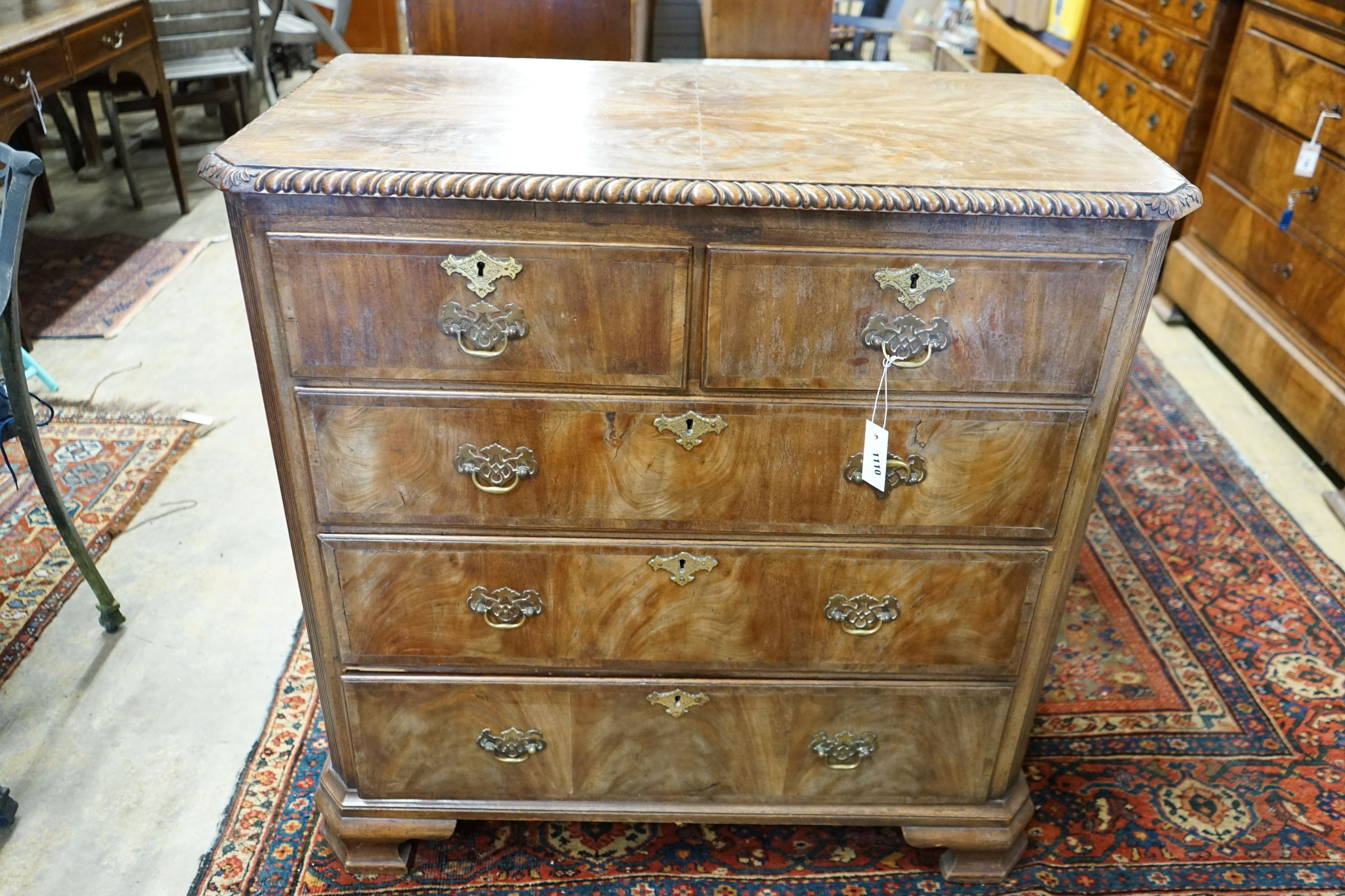 A George II style walnut chest with gadrooned top, width 98cm, depth 51cm, height 98cm